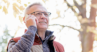 Man standing outdoors talking on mobile phone
