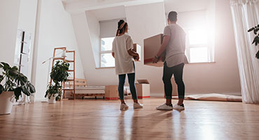 Woman with dog sitting on couch