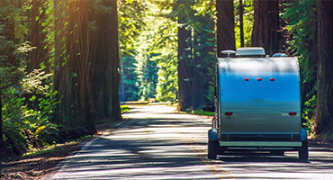 RV Trailer Driving Down Road