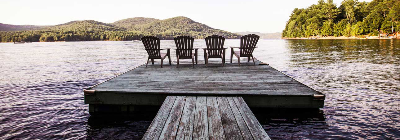 Picture of Adirondack chairs overlooking a lake