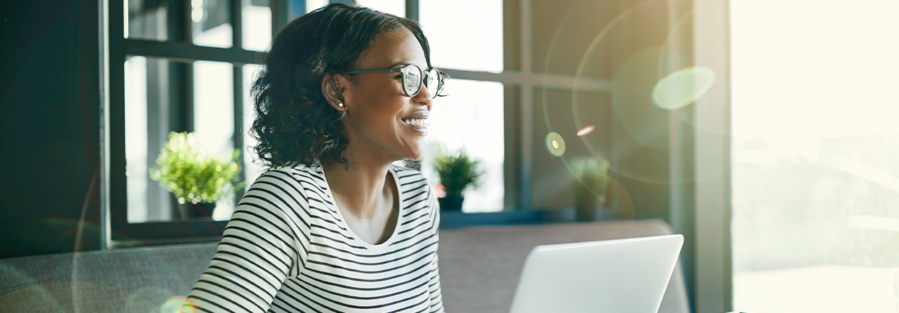 Woman sitting at desk smiling