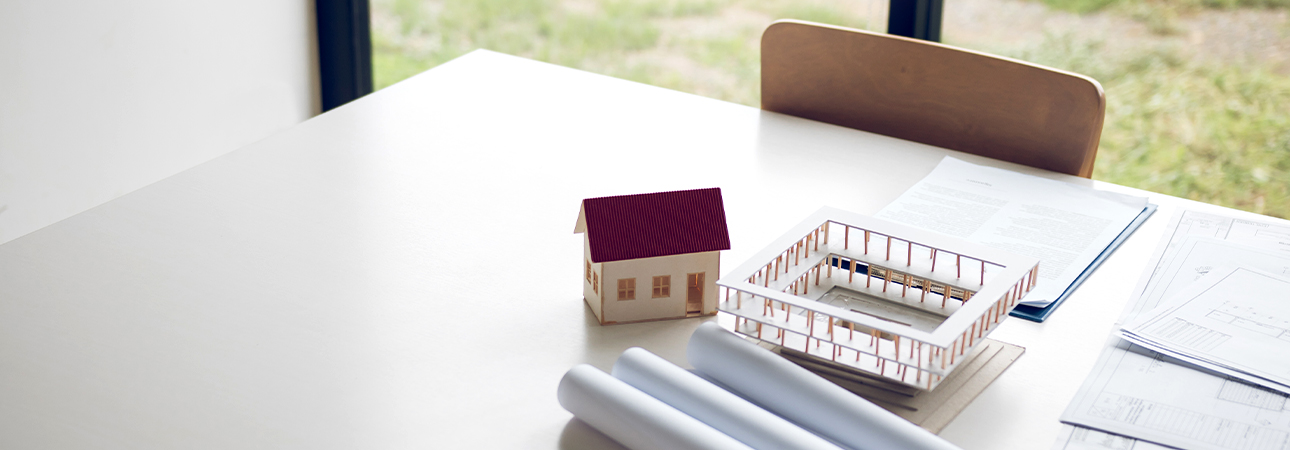 Papers, maps, and architectural models on a table